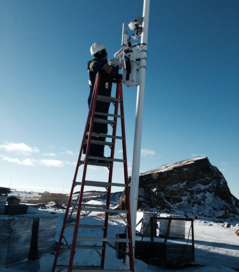 Setting up a Power Sentry on a clear day at a winter construction site.